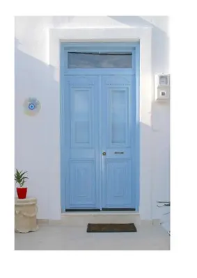 a blue door in a white room with a plant at Kuspa House Soroni in Soroni