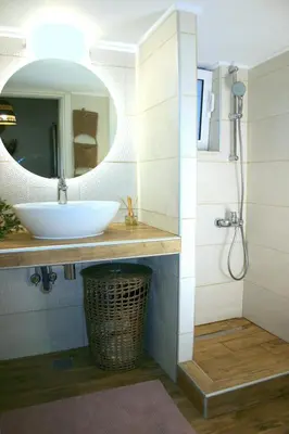 a bathroom with a sink and a mirror at Kuspa House Soroni in Soroni