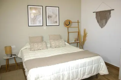 a bedroom with a bed and two pictures on the wall at Kuspa House Soroni in Soroni