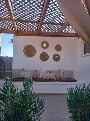 a living room with a couch and mirrors on the wall at Kuspa House Soroni in Soroni