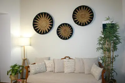 a living room with a couch and plates on the wall at Kuspa House Soroni in Soroni