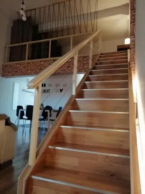a staircase in a house with wooden floors at KAZERMA ΗΟΜΕ in Rhodes Town
