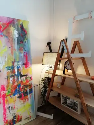 a room with a painting and a lamp and a ladder at KAZERMA ΗΟΜΕ in Rhodes Town