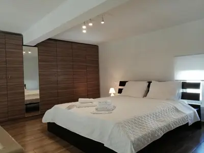 a bedroom with a large bed with two towels on it at KAZERMA ΗΟΜΕ in Rhodes Town