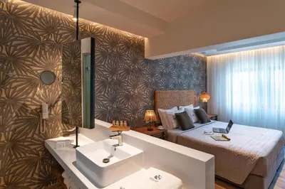 a bathroom with a bed and a sink in a room at Naillac Boutique Hotel in Rhodes Town