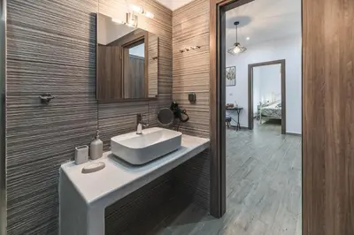 a bathroom with a white sink and a mirror at Casa Nikolou Stegna in Archangelos
