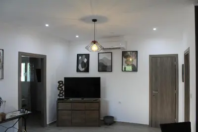 a living room with a television on a white wall at Casa Nikolou Stegna in Archangelos