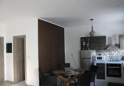a kitchen with a table and chairs in a room at Casa Nikolou Stegna in Archangelos