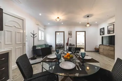 a dining room with a glass table and chairs at Casa Nikolou Stegna in Archangelos