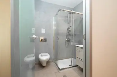 a bathroom with a shower and a toilet and a sink at Gravity Downtown Scandi Studio in Rhodes Town