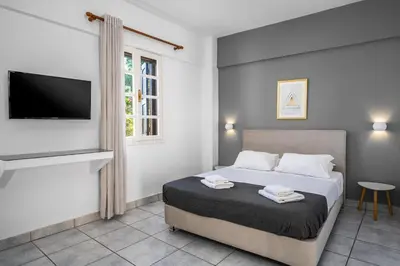 a bedroom with a bed with a flat screen tv at Cleomenes Old Town Studios in Rhodes Town