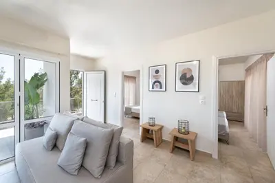 a living room with a couch and some windows at ANASTASIOS HOUSE STEGNA - UP FLOOR in Archangelos