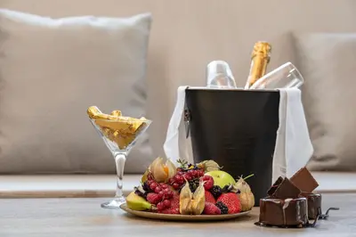 a plate of fruit and a glass of wine on a table at ANASTASIOS HOUSE STEGNA - UP FLOOR in Archangelos