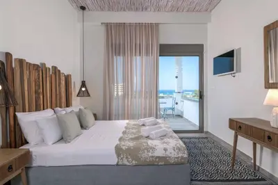 a bedroom with a bed with a view of the ocean at Villa Krini Delight in vlicha