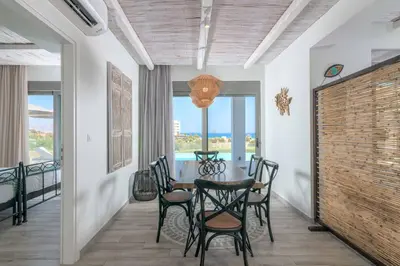 a dining room with a table and chairs at Villa Krini Delight in vlicha