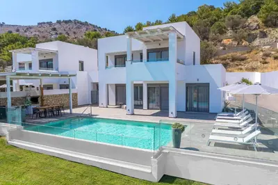 a large white house with a swimming pool at Villa Krini Delight in vlicha