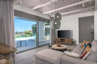 a living room with a couch and a tv at Villa Krini Myth in vlicha