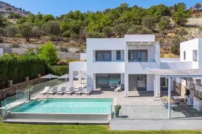 a villa with a swimming pool and a house at Villa Krini Myth in vlicha
