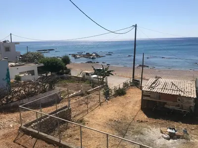 a truck parked on a beach near the ocean at GALINI STEGNA BEACH in Archangelos