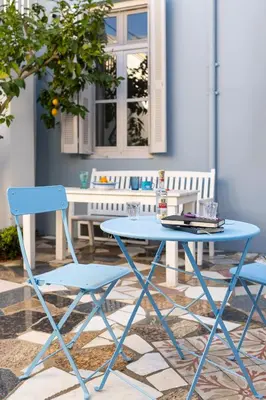 a blue table and two chairs on a patio at Beautiful Neoclassical House in Rhodes town in Rhodes Town
