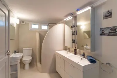 a bathroom with a sink and a toilet and a mirror at Beautiful Neoclassical House in Rhodes town in Rhodes Town