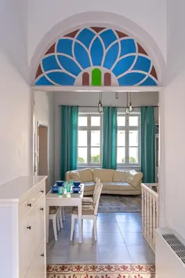 a living room with a table and a couch at Beautiful Neoclassical House in Rhodes town in Rhodes Town