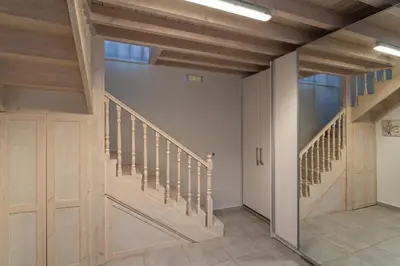 a hallway with wooden stairs and a glass door at Beautiful Neoclassical House in Rhodes town in Rhodes Town