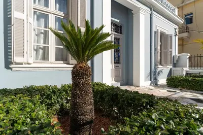 a palm tree in front of a house at Beautiful Neoclassical House in Rhodes town in Rhodes Town