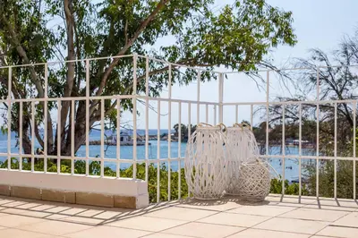 a metal fence with two bags next to a pool at Salty Beach Front House Faliraki in Faliraki