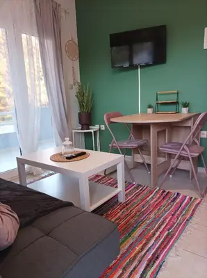 a living room with a couch and a table at Home Away From Home in Ixia