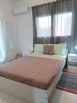 a large bed in a room with a window at Home Away From Home in Ixia