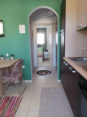 a kitchen with an archway leading to a bathroom at Home Away From Home in Ixia