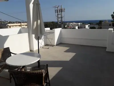 a white umbrella sitting on top of a roof at Pefki Irish Seaview in Pefki Rhodes