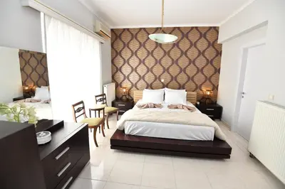 a bedroom with a large bed with a wall at Eva's Garden House in Ialyssos