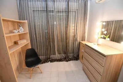 a room with a desk and a chair in front of a window at Eva's Garden House in Ialyssos