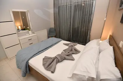 a bedroom with a bed with bows on it at Eva's Garden House in Ialyssos