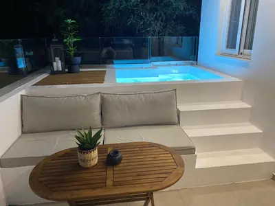 a living room with a couch and a table at Theros Luxury Apartment in Archangelos
