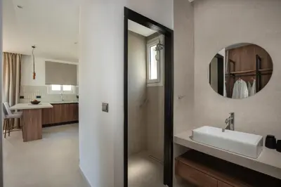 a bathroom with a sink and a mirror at Theros Luxury Apartment in Archangelos
