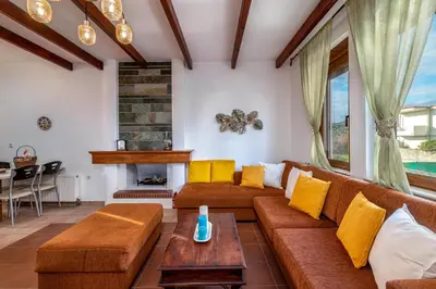 a living room with a couch and a fireplace at Evilion Villa in Gennadi
