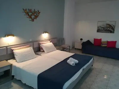 a bedroom with a bed with a stuffed animal on it at Stonegarden Studios in Faliraki