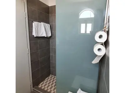 a bathroom with a shower with two toilets at Stonegarden Studios in Faliraki