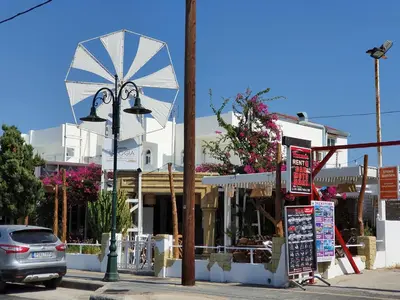 a street view of a store with a waterwheel at Stonegarden Studios in Faliraki