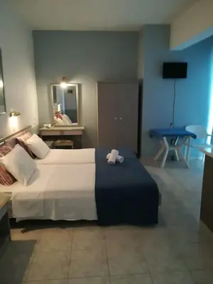 a bedroom with a large bed with a towel on it at Stonegarden Studios in Faliraki