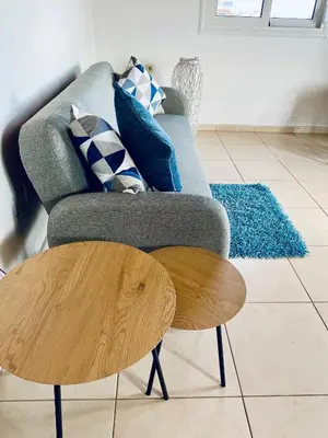 a living room with a couch and a wooden coffee table at The Citrus House in Kalavárda