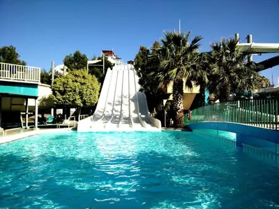 a large swimming pool with a water slide at The Citrus House in Kalavárda