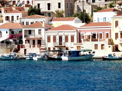a group of boats docked in the water near houses at The Citrus House in Kalavárda
