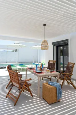 a dining room with a table and two chairs at Domus Oliva Villas in Haraki