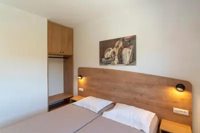 a bedroom with a bed with a wooden head board at Domus Oliva Villas in Haraki