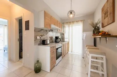 a kitchen with wooden cabinets and a stove top oven at City Center Elite Suite in Rhodes Town