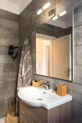 a bathroom with a sink and a mirror at City Center Elite Suite in Rhodes Town